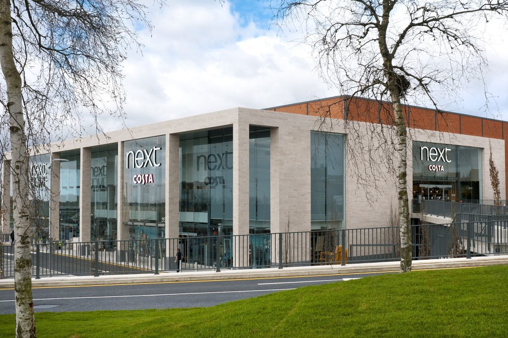 Exterior of Next High Wycombe with Jura Beige limestone lightweight stone facade.