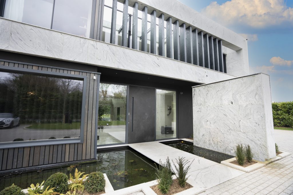 Selbourne House exterior with lightweight stone cladding panels and landscaped garden.