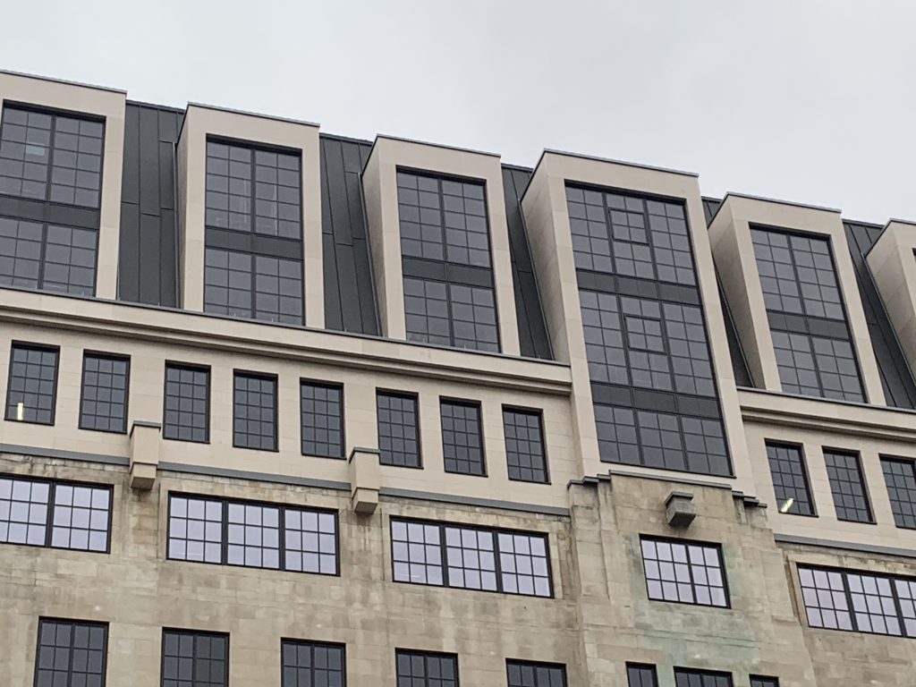 Candlewick project showing dormer windows of lightweight Moleanos cladding on two-storey extension on top of existing Portland facade.