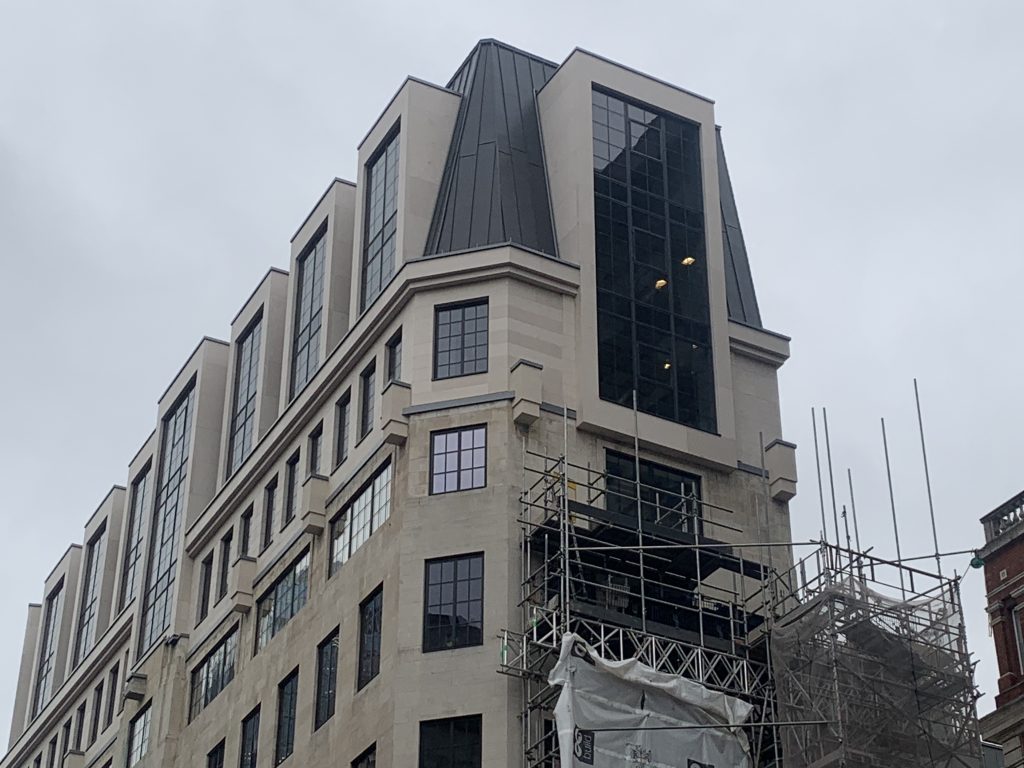 Candlewick project showing lightweight Moleanos cladding on two-storey extension on top of existing Portland facade midway through installation.