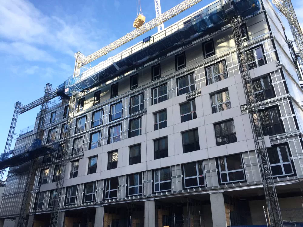 Travelodge Aldgate midway through installation of lightweight stone cladding panels on external facade, showcasing progress on modern stone cladding system integration.